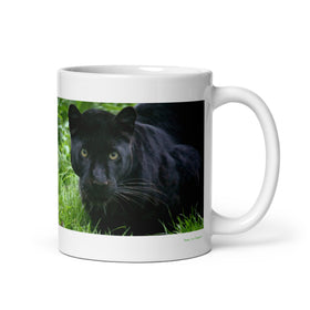 11 oz. white ceramic black leopard mug showing a black leopard in its natural habitat