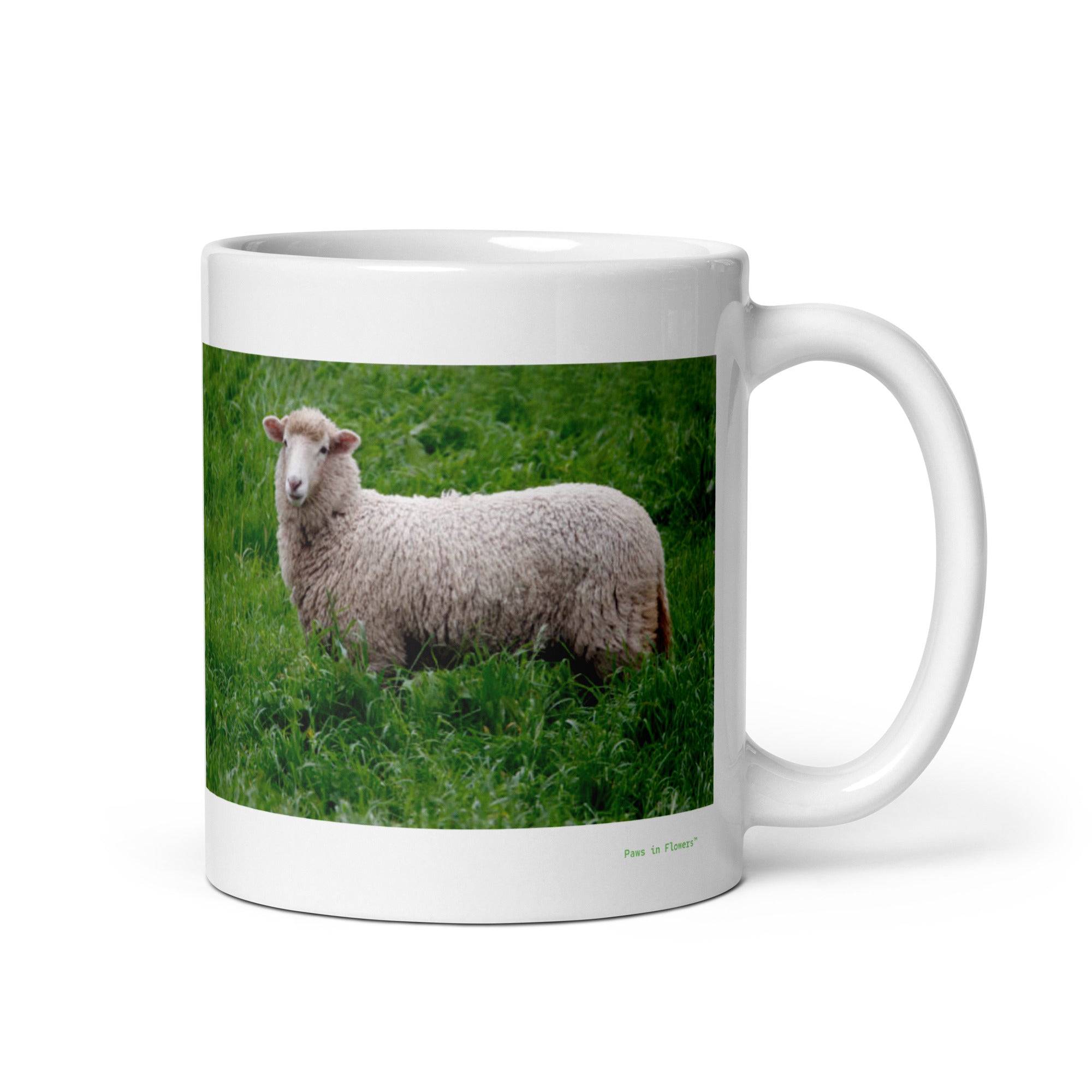 11 oz. white ceramic sheep mug showing a sheep in its natural habitat