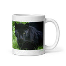 11 oz. white ceramic black leopard mug showing a black leopard in its natural habitat