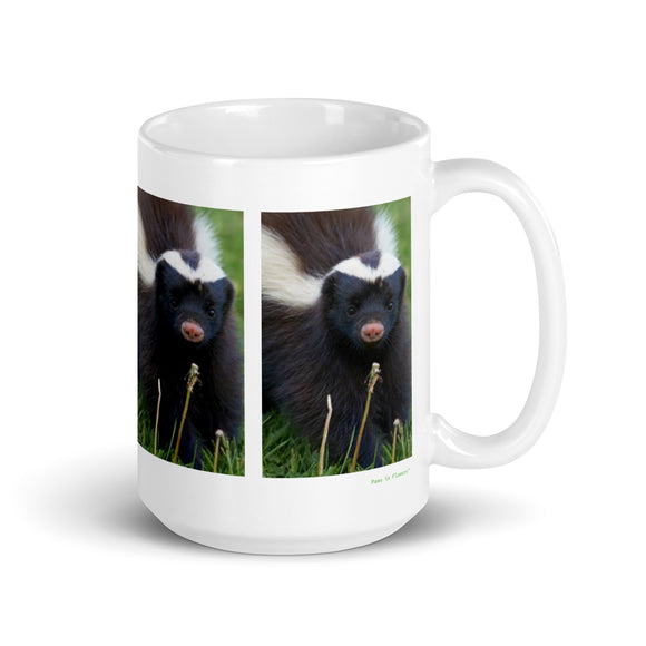 15 oz. white ceramic skunk mug showing a skunk in its natural habitat