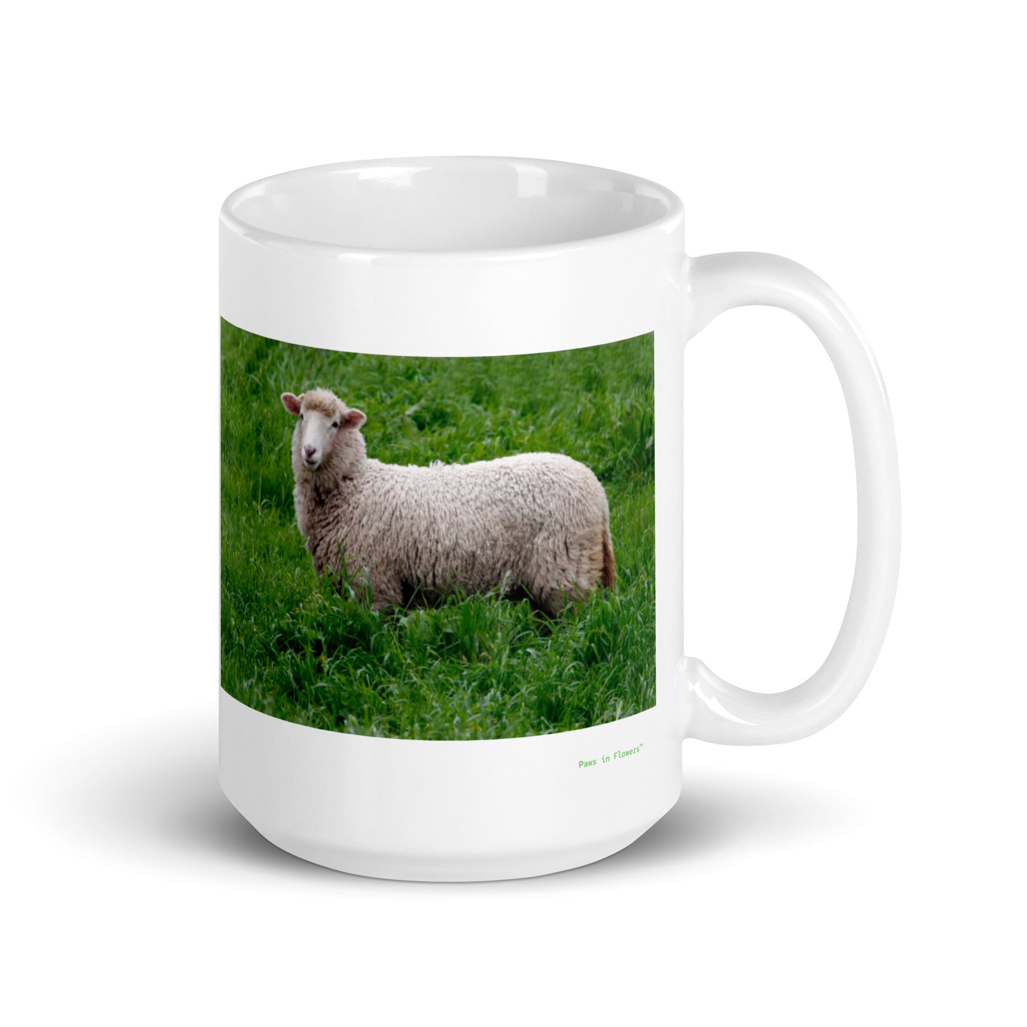15 oz. white ceramic sheep mug showing a sheep in its natural habitat