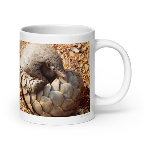 20 oz. white ceramic pangolin mug showing a pangolin in its natural habitat