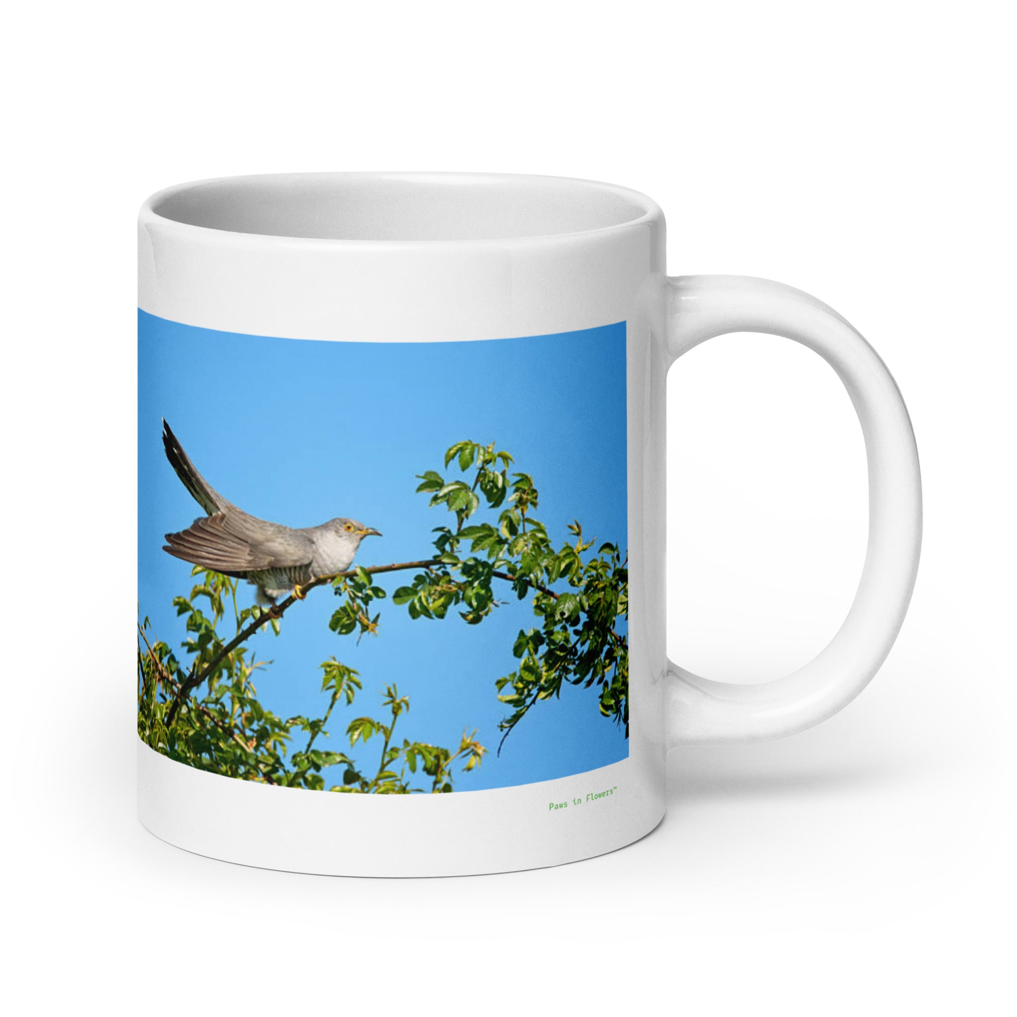 20 oz. white ceramic cuckoo mug showing a cuckoo in its natural habitat