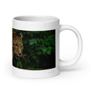 20 oz. white ceramic amur leopard mug showing an amur leopard in its natural habitat