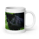 20 oz. white ceramic black leopard mug showing a black leopard in its natural habitat