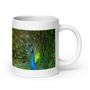 20 oz. white ceramic peacock mug showing a peacock in its natural habitat
