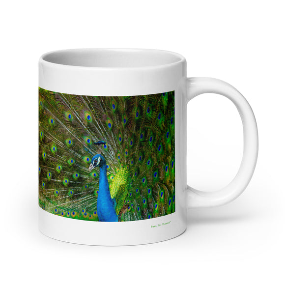 20 oz. white ceramic peacock mug showing a peacock in its natural habitat